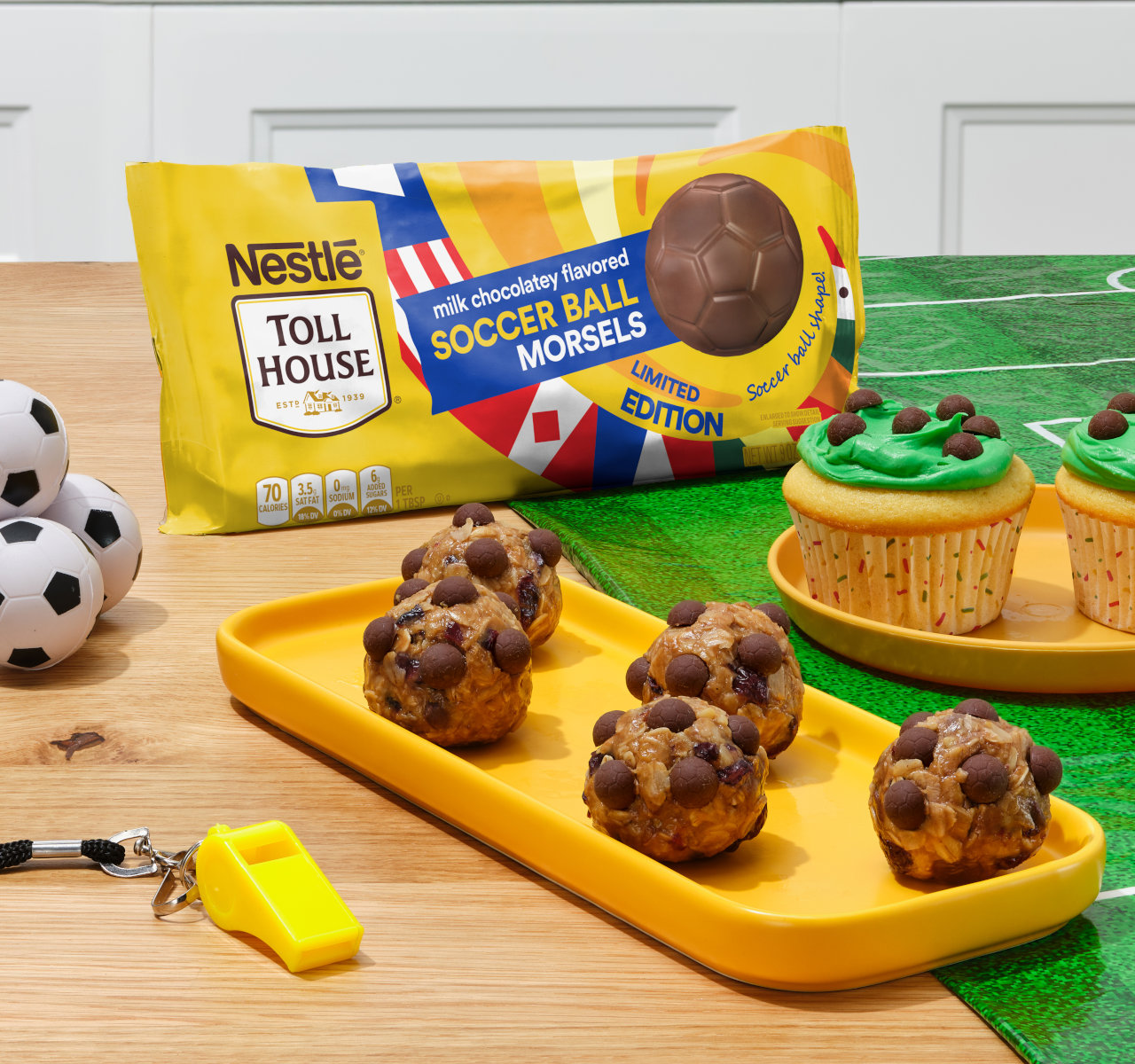 Chocolate chip cookie clusters on yellow tray with Nestle Toll House bag and soccer cupcakes