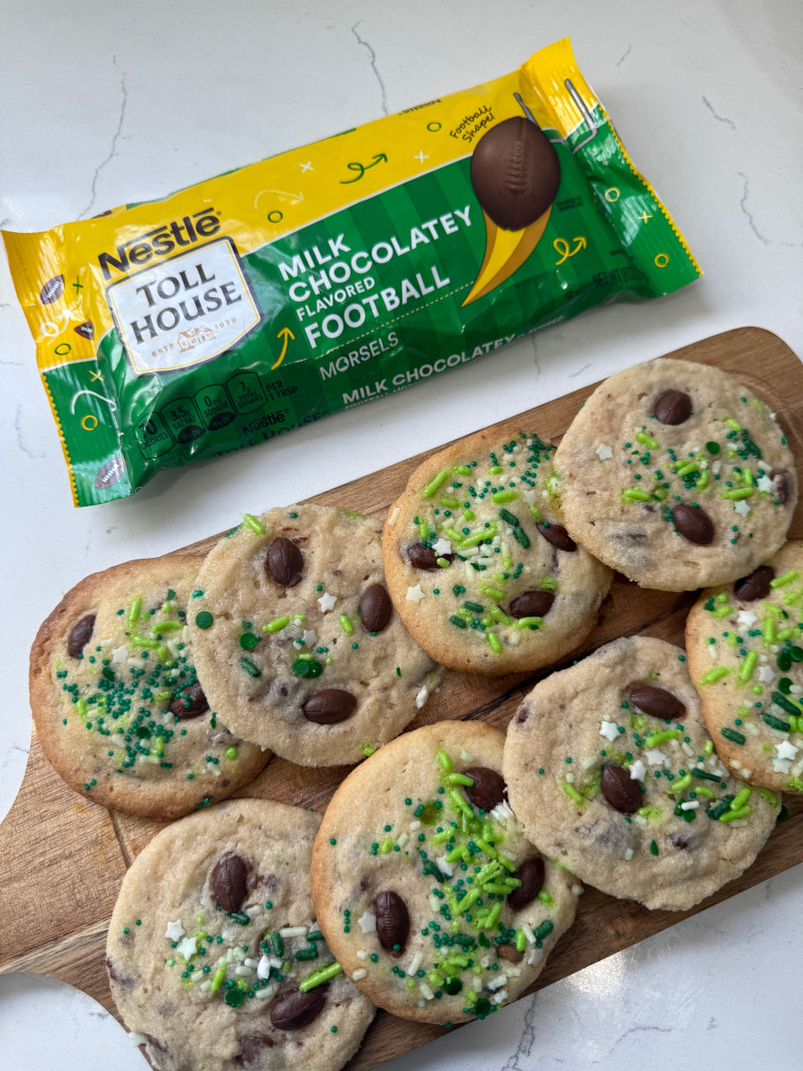 Photo of football-themed cookies topped with chocolate candies and green sprinkles, wrapper