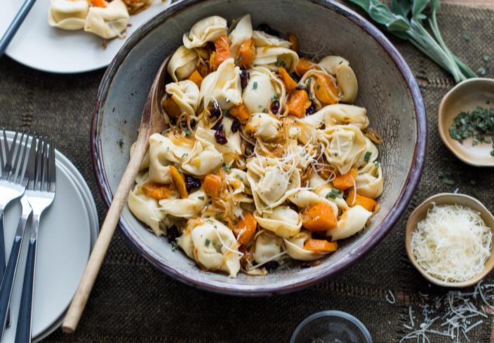 Tortellini con calabaza, cebolla y arándanos.