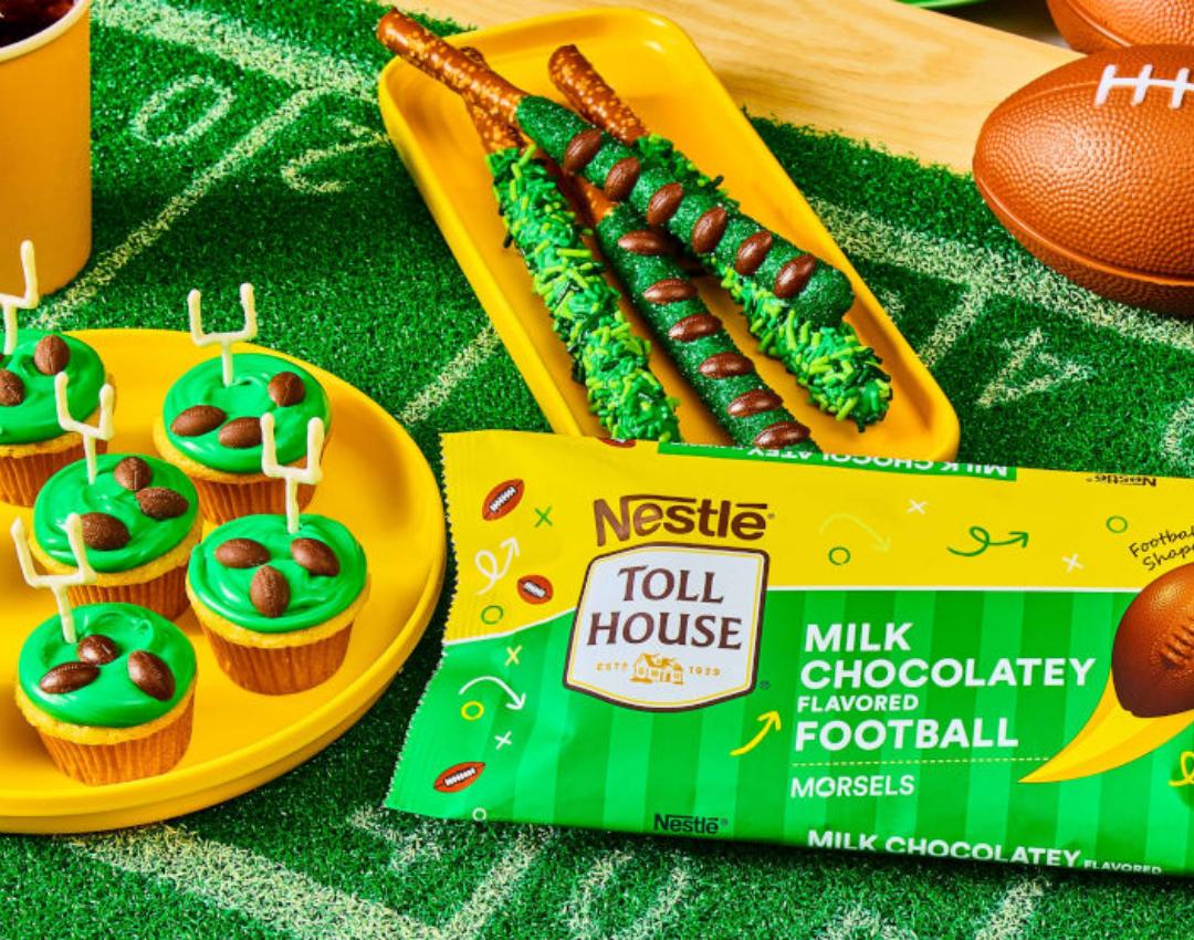 Team Color Cupcakes by NESTLÉ® TOLL HOUSE®, with colorful frosting and Football Morsels, on a white plate.