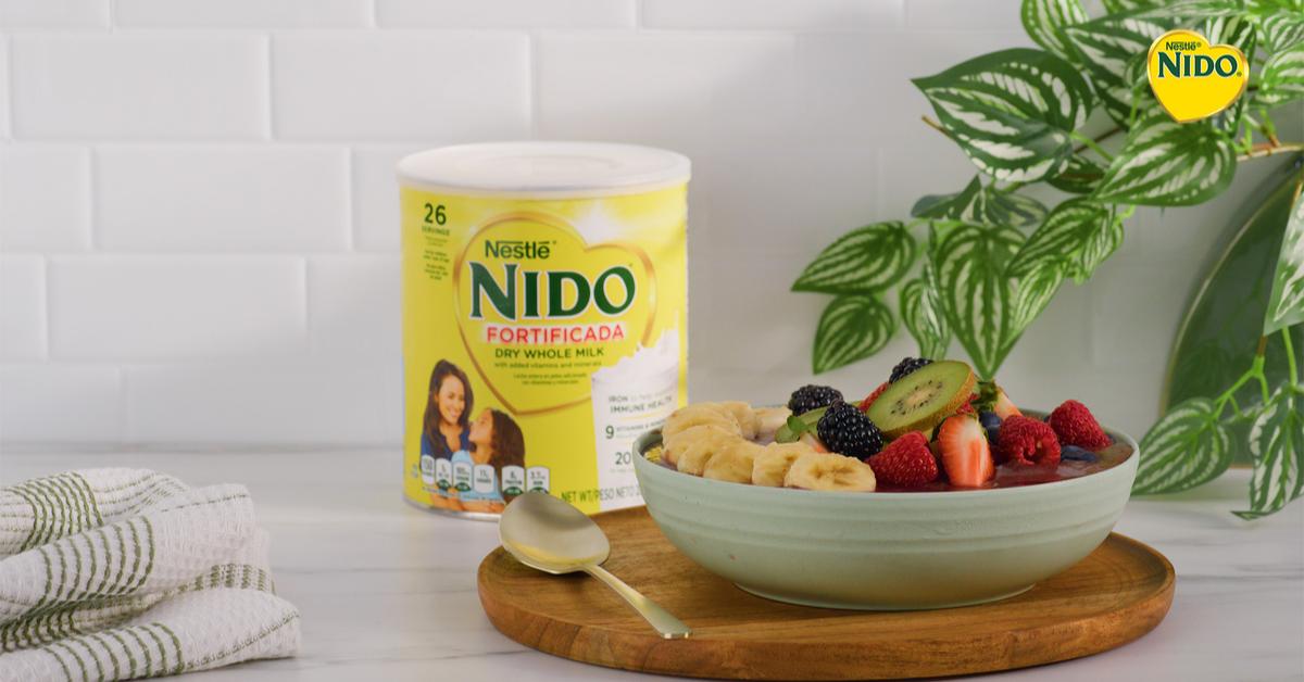 Acai Bowl by Official NIDO®, featuring acai, NIDO Fortificada, fresh berries, banana slices, granola, and shredded coconut.