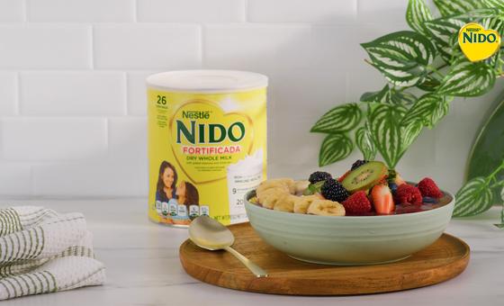 Acai Bowl by Official NIDO®, featuring acai, NIDO Fortificada, fresh berries, banana slices, granola, and shredded coconut.