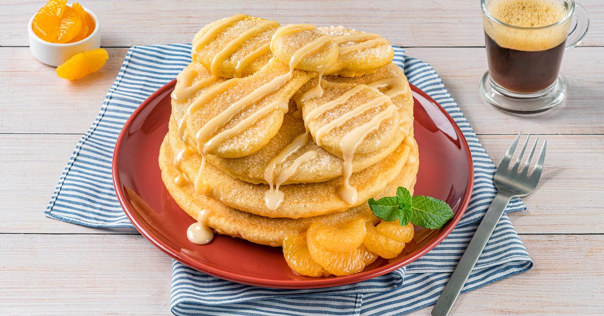 Pan de Muerto Pancakes by LA LECHERA®, made with CARNATION® Evaporated Milk, topped with Sweetened Condensed Milk.