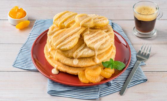 Pan de Muerto Pancakes by LA LECHERA®, made with CARNATION® Evaporated Milk, topped with Sweetened Condensed Milk.