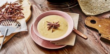 Blumenkohlcremesuppe mit blauen Strohkartoffeln