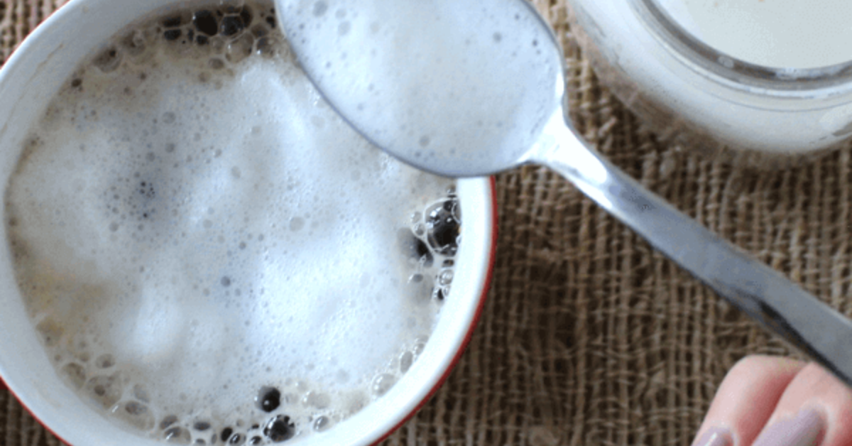 Café Au Lait by Seattle’s Best Coffeeᵀᴹ, Very Vanilla or Toasted Hazelnut, in a white cup on a wooden table.