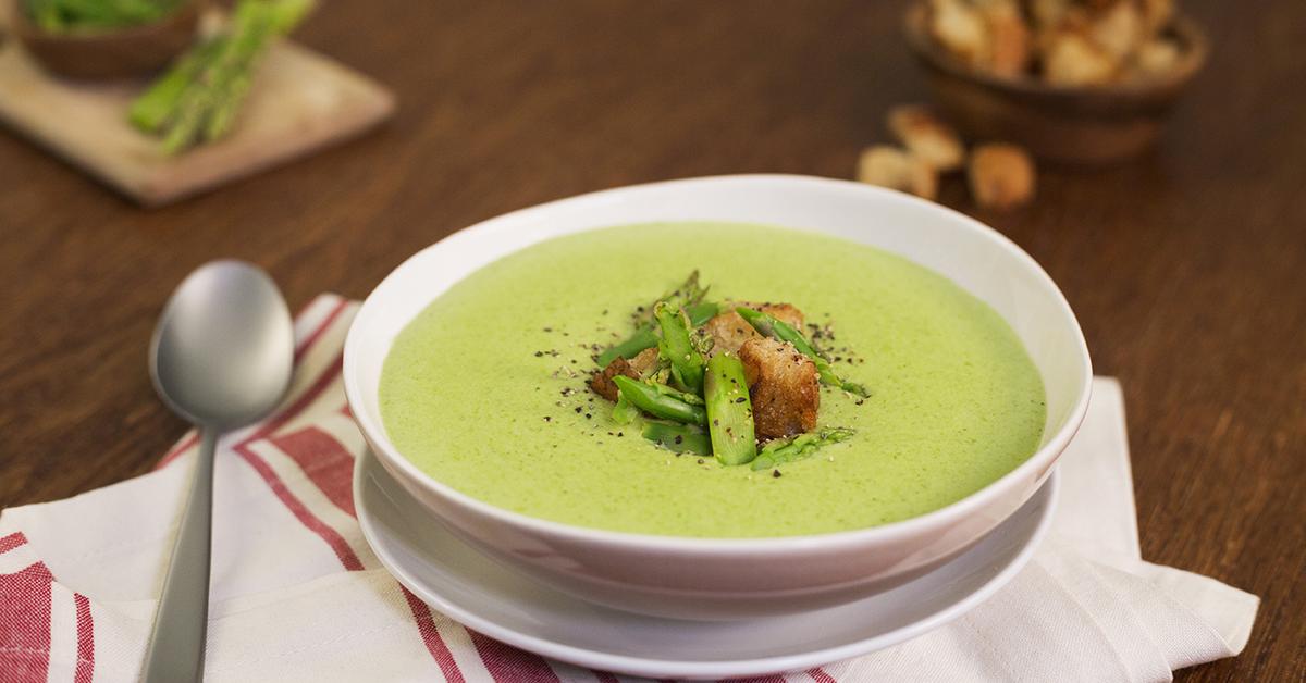Cream of Asparagus Soup by MEDIA CREMA, creamy with NESTLÉ® CARNATION® Evaporated Milk, garnished with asparagus spears.