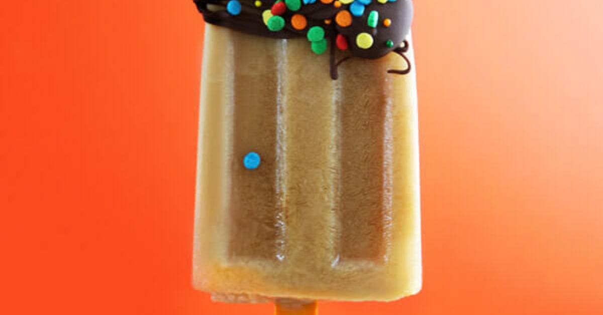 Frozen Coffee Pops by Seattle’s Best Coffeeᵀᴹ, made with brewed House Blend, served with assorted toppings on a wooden board.