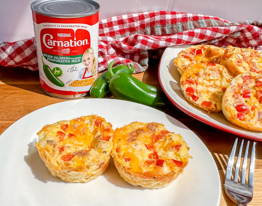 Egg bites with jalapeño milk, garnished with herbs, served on a white plate.