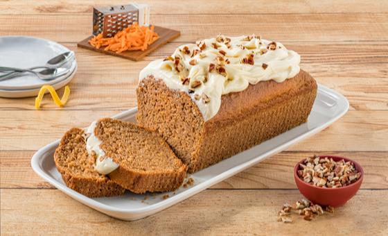 Carrot Pound Cake by LA LECHERA®, made with CARNATION® Evaporated Milk, topped with cream cheese frosting.