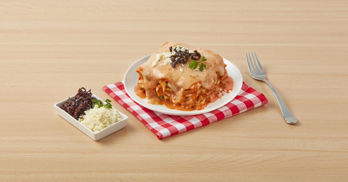 Red lasagna with Media Crema, Carnation Milk, Maggi Bouillon, topped with Manchego cheese.