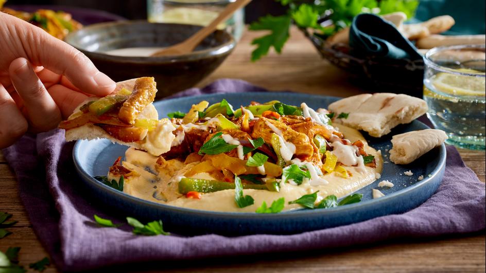 Orientalisches Hähnchen mit Gemüse auf Hummus